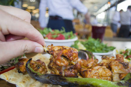 fried chicken in hand in restaurant