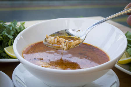chicken soup with noodles and vegetables in white bowlの写真素材
