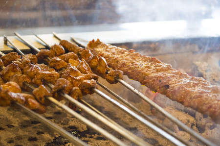 turkish style kebab cooking adana kebabs on the restaurant style grill smoke coming out from them