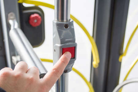 man pressing button on bus