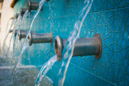 clean water running from many turkish taps with sparkling dropsの写真素材