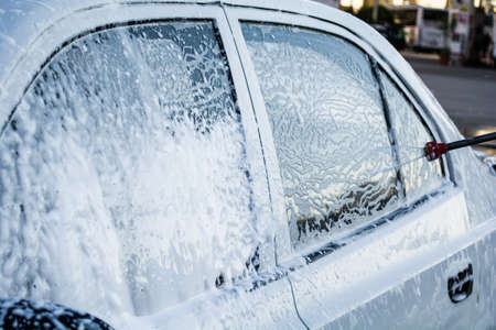 cleaning the car with foam car wash shopの写真素材
