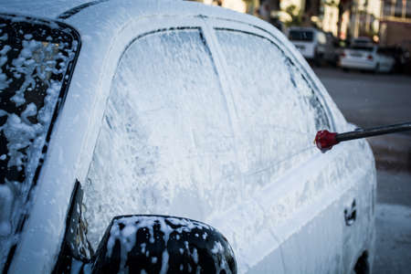 cleaning the car with foam car wash shopの写真素材