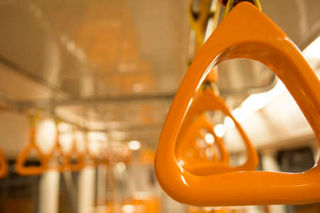 orange handles for standing passenger inside a metroの写真素材