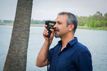 Man with old vintage camera in hands.