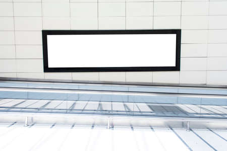 One big horizontal / landscape orientation blank billboard in public transport with blurred...
