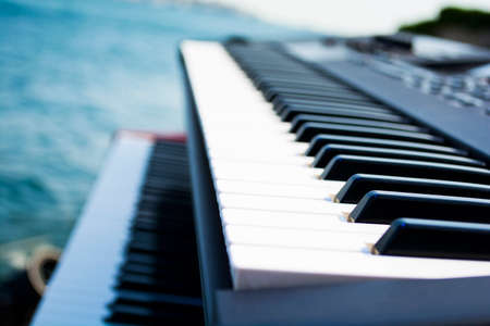piano keyboard and ocean or sea in the background