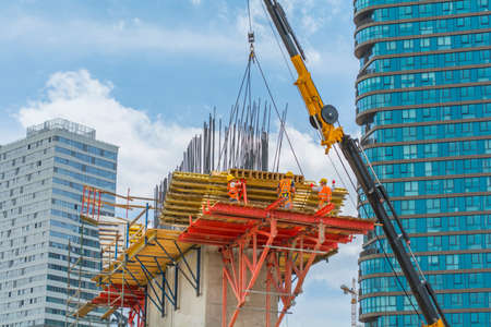 Engineers and construction workers are working on road construction bridge