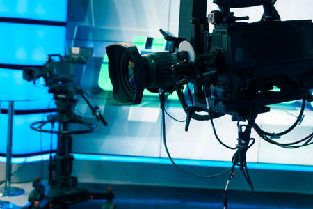 Broadcast television studio camera and crane camera in news studio room with LED lightsのeditorial素材