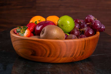Healthy food: mix from fruits in bowl, old marble background, selective focusの写真素材