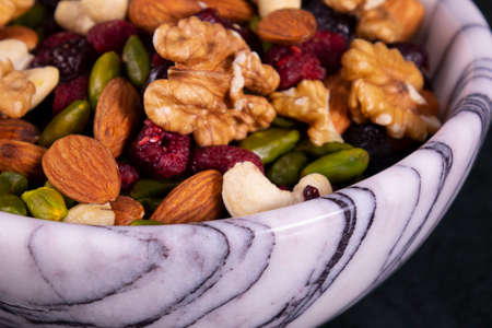 Nuts mix in a marble plateの写真素材