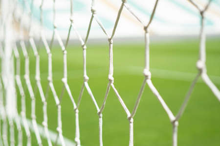 white football net, green grass backgroundの写真素材