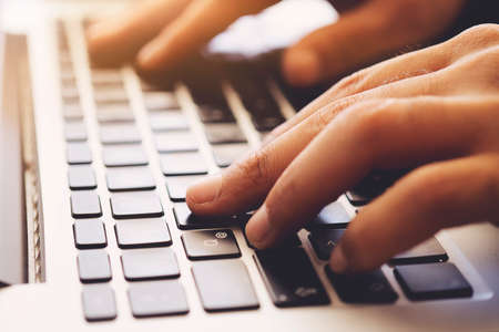 Business man using laptop computer. Male hand typing on laptop keyboardの写真素材