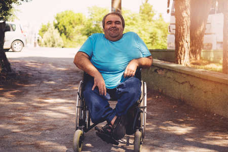 disabled man in wheelchair walking parkの写真素材