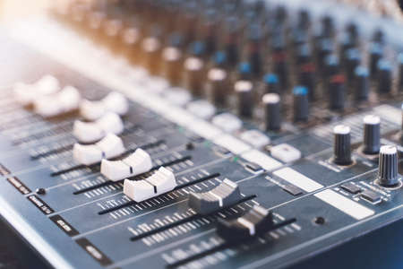 Sound mixer. Professional audio mixing console with lights, buttons, faders and sliders.の写真素材