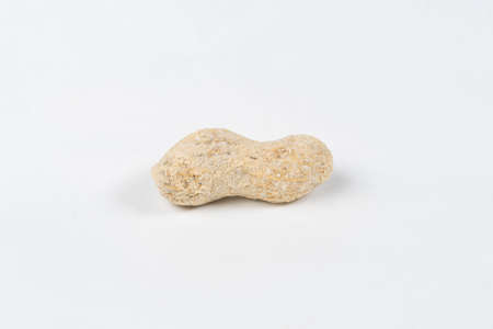 Shelled salted peanut on white background