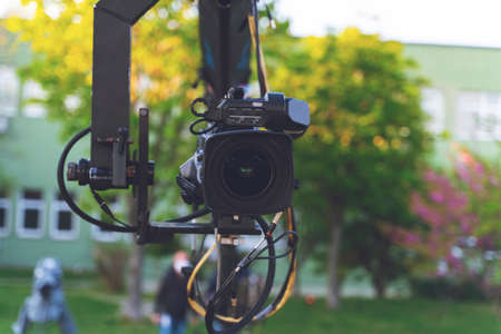 broadcast camera on the crane tripod for easy to shooting or recording and broadcasting content in outdoors studioの写真素材
