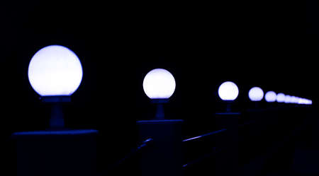 Lamps along a walkway in dark nightの写真素材