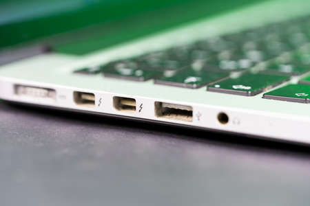 Close up side view of laptop computer. Old and dirty USB port.の写真素材