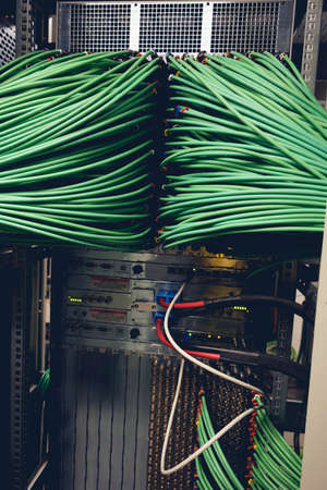 Close up view of internet equipment and cables in the server room. Broadcast system room.の写真素材