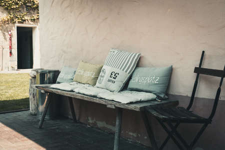 Rustic wooden bench with different pillows, vintage look. Inscription "Favorite Place" means "favorite place".の写真素材