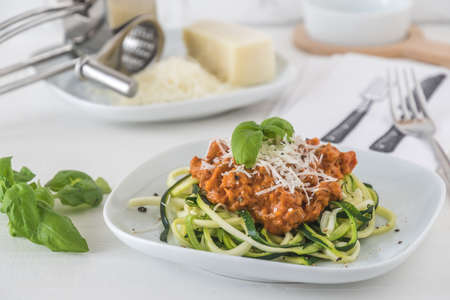 Zoodles bolognese: zucchini noodles with meat or vegan soy meat sauce and parmesan. For low carb, keto, paleo nutrition.の写真素材