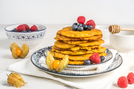 Pile of vegan pancakes with berries on white background, copy spaceの写真素材
