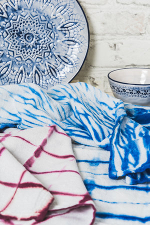 Handmade tea towels in blue and wine red colors with shibori or batik technic, verticalの写真素材