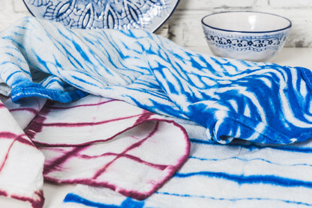 Handmade tea towels in blue and wine red colors with shibori or batik technicの写真素材