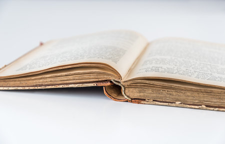 Old antique open book on white background, isolatedの写真素材