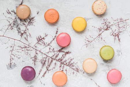 Colorful french macarons on white rustic background, top viewの写真素材