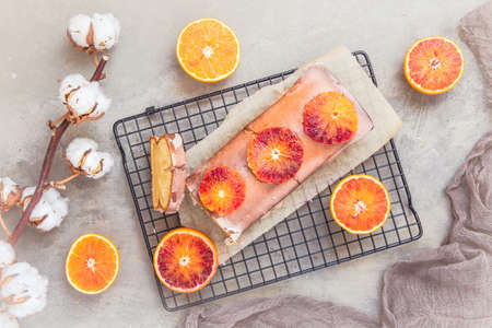 Homemade blood orange cake with blood orange glaze on gray concrete background, top viewの写真素材