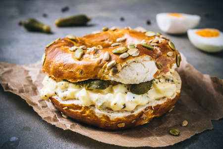 Bagel bun sandwich with egg salad on gray backgroundの写真素材