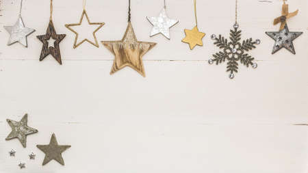 Christmas frame made of white, golden and silver christmas decorations on white background. Flat lay, top view, copy spaceの写真素材