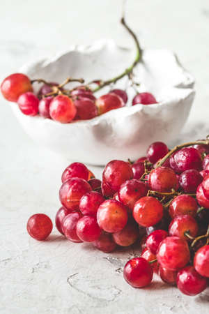 Fresh ripe red grapes on white background, verticalの写真素材