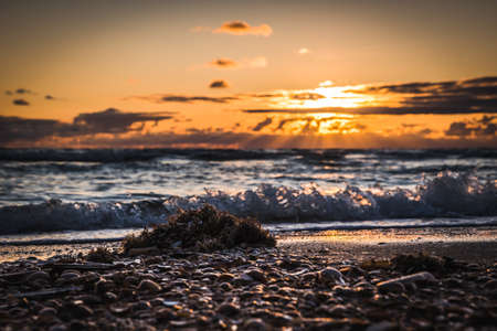Beautiful sunset at a cloudy sky over the beach. Taken on danish island Romoの写真素材