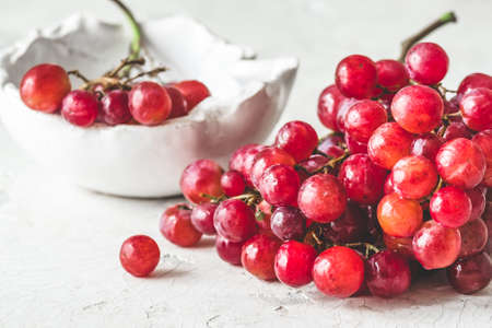 Fresh ripe red grapes on white backgroundの写真素材