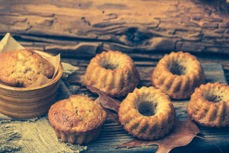 Homemade mini guglhupf, bundt cakes, muffins, on rustic wooden backgroundの写真素材