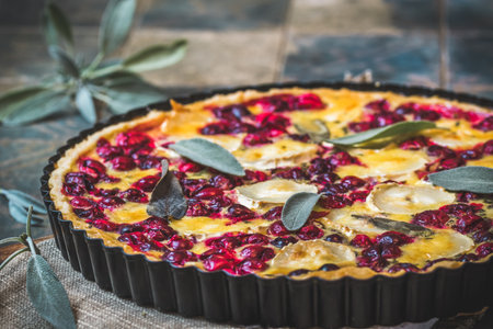 Cranberry goat cheese tart with sage on rustic blue backgroundの写真素材