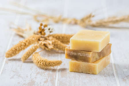 Three pieces of natural soap on white wooden backgroundの写真素材
