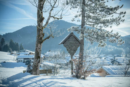 Snowy landscape in the Alps on a sunny winter morning, desaturated colorsの写真素材