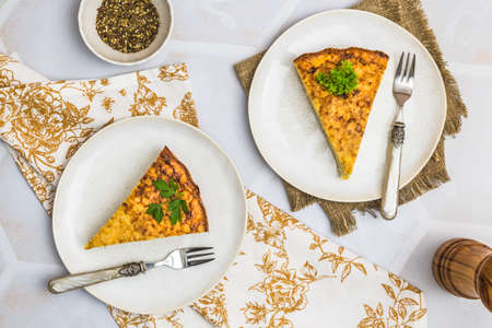 Two pieces of a potato cake, spanish tortilla, frittata, on white background, top viewの写真素材