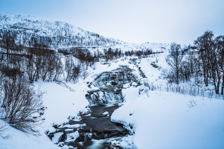 Waterfall on the Ersfjordelva river in winter, Ersfjordbotn, Troms, Norwayの写真素材
