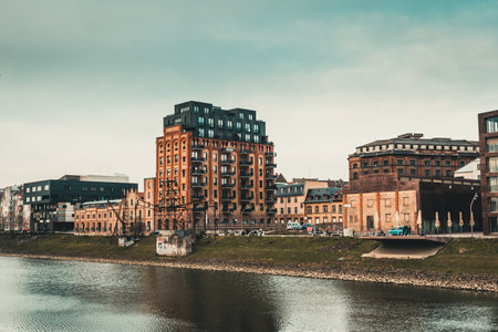 Mannheim, Germany - March 26, 2021: River bank with brick factory buildings renovated into...