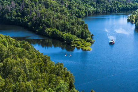 Two people on the largest double rope slide 120m above the abyss of the Rappbodetalsperre in the...