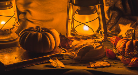 Cozy autumn decoration on a balcony with lanterns, pumpkins, woolen blankets and leavesの写真素材