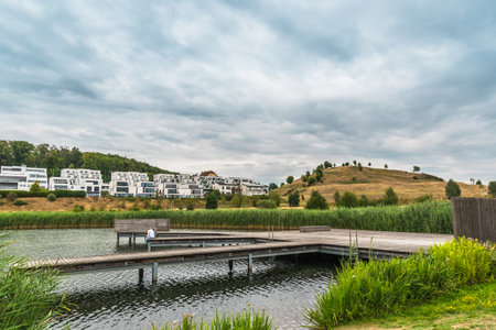 View of the Phoenix lake (Phoenixsee) in Dortmund, Germany, with modern villas and the Kaiserberg hill, copy spaceの写真素材