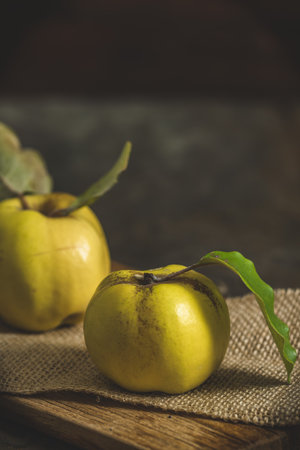 where quinces on a rustic wooden tableの写真素材