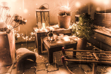 Wintry snowy outdoor Christmas decorations with sleigh, lanterns and fairy lightsの写真素材