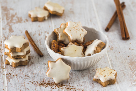 Christmas cinnamon star cookies on a white wooden tableの写真素材